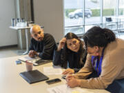 Fourth Plain Forward program manager Will Fuentes, from left, social media coordinator Almendra Velazquez and community development manager Sheila Davis work on a project at Fourth Plain Community Commons in February in Vancouver. Fourth Plain Forward got a grant from the state for climate justice projects.