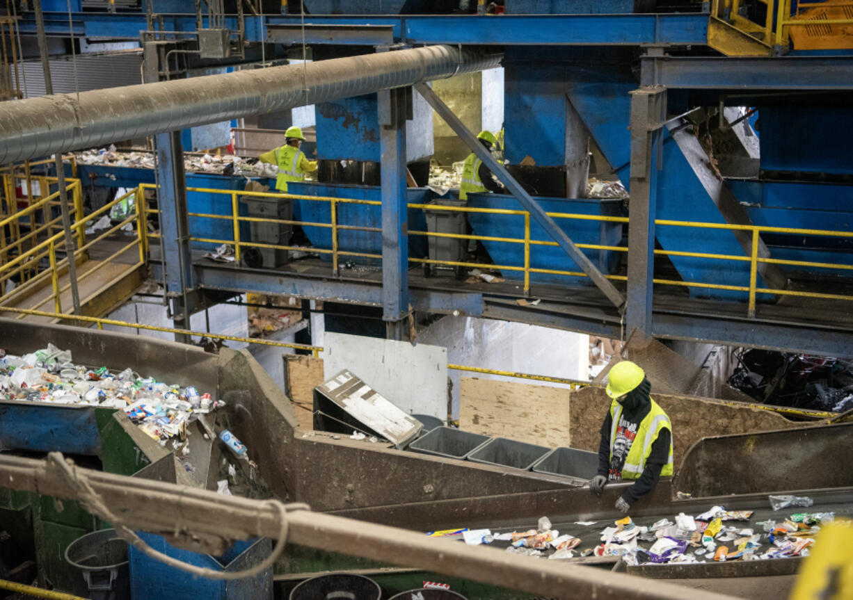 Workers sort material Monday at West Vancouver Materials Recovery Center. A recent study by Waste Connections found little change in the total weight of plastic being recycled since the state&rsquo;s plastic bag ban was in place.