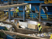 Workers sort material Monday at West Vancouver Materials Recovery Center. A recent study by Waste Connections found little change in the total weight of plastic being recycled since the state&rsquo;s plastic bag ban was in place.