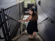 Heidi Leonard of Vancouver walks downstairs through her apartment building complex. Leonard lives at The Pacific and said the supportive housing needs more security and accountability.