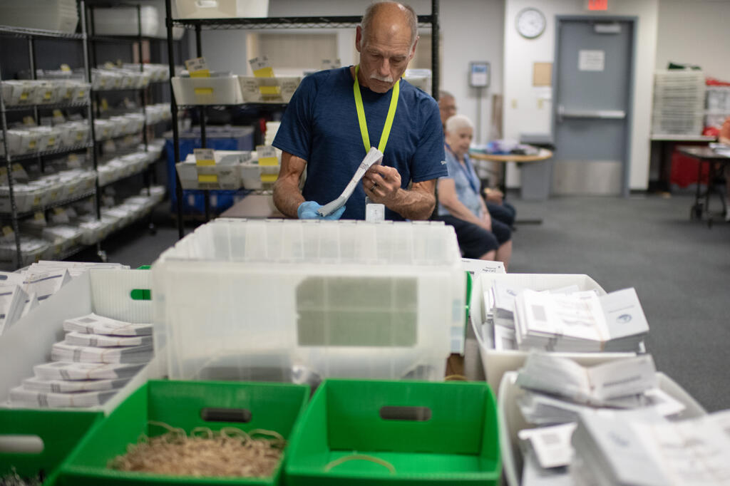 Greg Ericksen of the Clark County Elections Office helps sort through ballots during the primary election on Tuesday afternoon, Aug. 6, 2024.