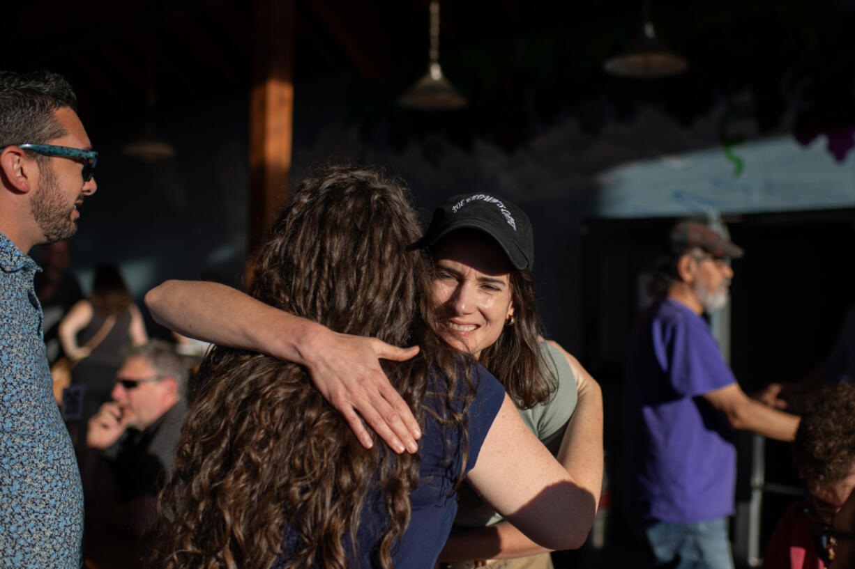 U.S. Rep. Marie Gluesenkamp Perez, facing, greets supporters at a primary election party at Heathen Brewing on Tuesday evening. &ldquo;This election is about Southwest Washington coming together to stop Joe Kent and his angry, dangerous, divisive, extreme politics,&rdquo; she said.