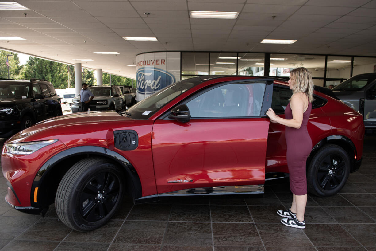 Sierra Banks, sales and leasing consultant at Vancouver Ford, gets behind the wheel of a 2023 Mustang Mach-E for a media photo Thursday afternoon.