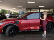 Sierra Banks, sales and leasing consultant at Vancouver Ford, gets behind the wheel of a 2023 Mustang Mach-E for a media photo Thursday afternoon.