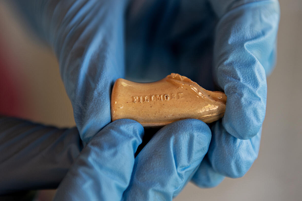 Lean in closely to make out the name &ldquo;Fillmore&rdquo; on this glazed clay pipe fragment, held in the gloved hands of Meagan Huff, curator at Fort Vancouver National Historic Site. Archaeologists have found thousands of pipe fragments in and around the fort site, including &ldquo;president pipes&rdquo; dated to election campaigns of the 1840s and 1850s, Huff said.