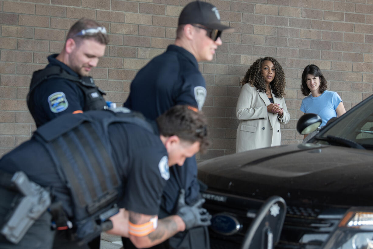 Monica Alexander, second from right, executive director of the Criminal Justice Training Commission, joins U.S. Rep. Marie Gluesenkamp Perez, D-Skamania, as they watch a mock training exercise of a traffic stop for a suspect with a warrant Wednesday at the law enforcement training academy in Vancouver. Perez heard from those involved about the importance of funding the training of new police officers while touring the facility that opened in January.