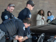 Monica Alexander, second from right, executive director of the Criminal Justice Training Commission, joins U.S. Rep. Marie Gluesenkamp Perez, D-Skamania, as they watch a mock training exercise of a traffic stop for a suspect with a warrant Wednesday at the law enforcement training academy in Vancouver. Perez heard from those involved about the importance of funding the training of new police officers while touring the facility that opened in January.