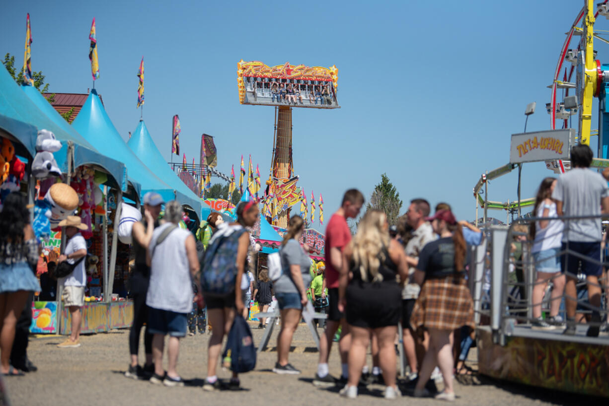 Amanda Cowan/The Columbian files
A crowd of thrill seekers enjoy rides and games at the Clark County Fair on Aug. 5.