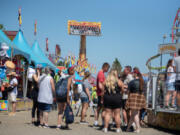 Amanda Cowan/The Columbian files
A crowd of thrill seekers enjoy rides and games at the Clark County Fair on Aug. 5.