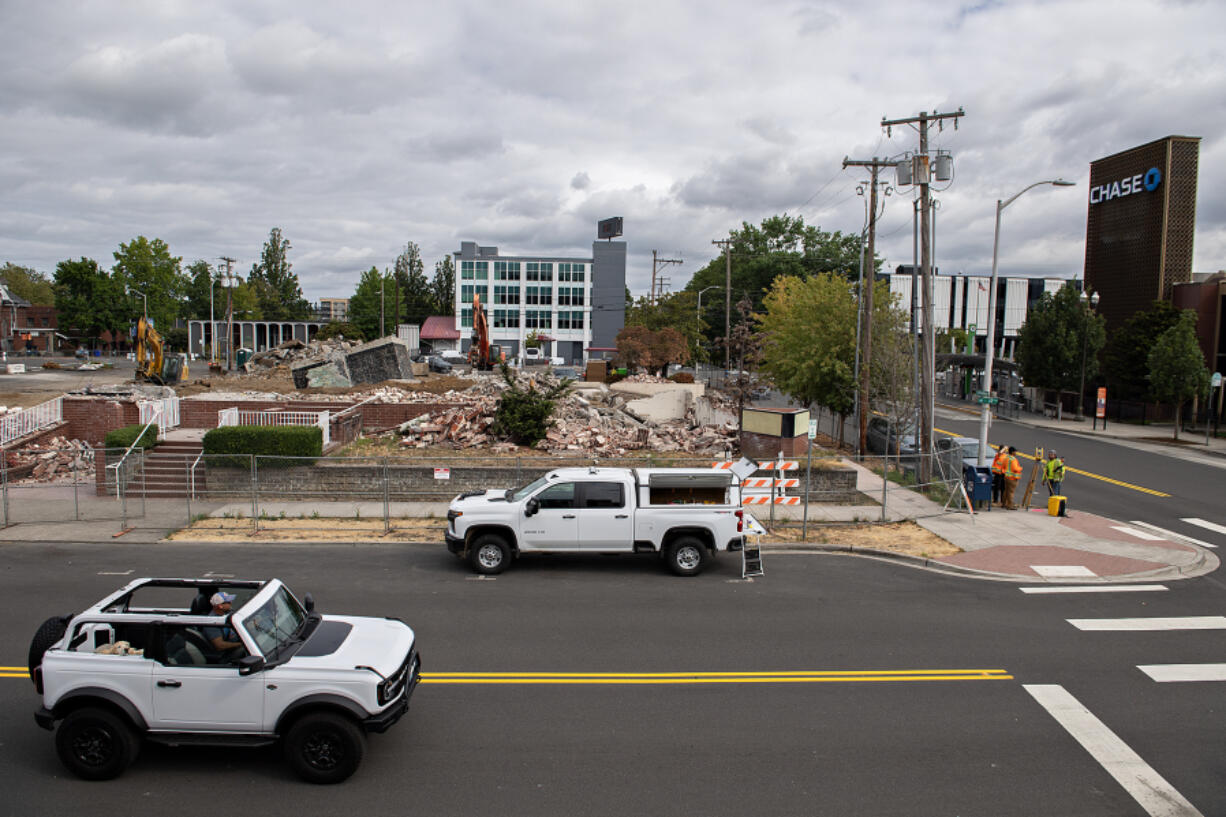 A motorist passes the demolition of several buildings including the old Vancouver Funeral Chapel in downtown Vancouver.