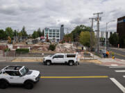 A motorist passes the demolition of several buildings including the old Vancouver Funeral Chapel in downtown Vancouver.