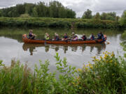 Rainy Rau of the Water Resources Education Center, left, leads a canoe tour after leaving Felida Moorage &amp; Marine Service on Thursday morning Paddlers had the opportunity to learn about wildlife, water quality and treatment plans for the algae during the excursion.