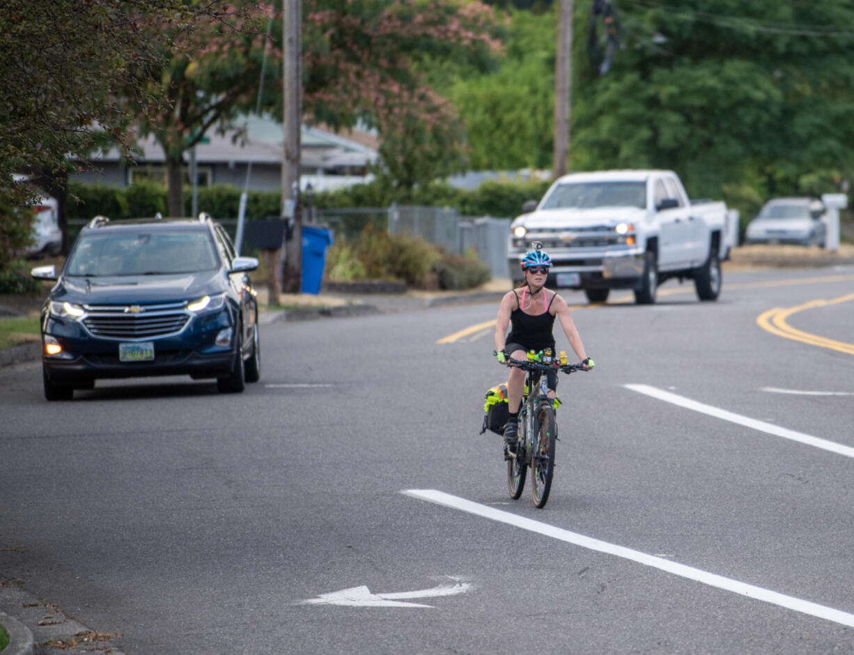 Riding in traffic where there&rsquo;s no bike lane, Sara Schmit approaches the busy intersection of Mill Plain Boulevard and Southeast 98th Avenue in Vancouver. Schmit has been a dedicated all-season bike commuter for years, and said she learned how to do it safely and comfortably the hard way: trial and error.