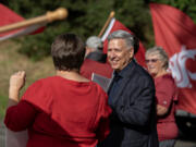 Washington State University Vancouver Chancellor Mel Netzhammer joins faculty and supporters in celebrating a new school year Aug. 19. Netzhammer announced Wednesday morning he will step down from his position next summer after 13 years on the job.