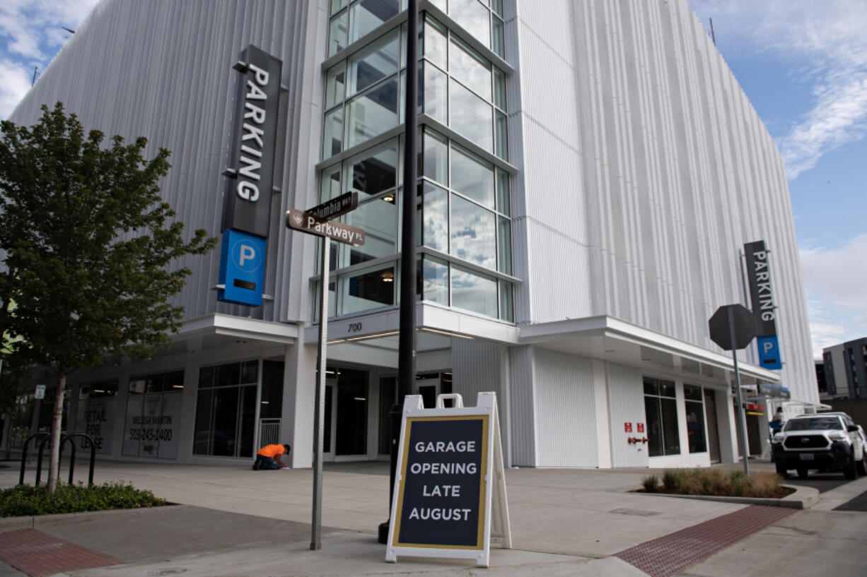 Crews put the finishing touches on the new eight-story parking garage Tuesday morning at The Waterfront Vancouver. The facility, scheduled to open Monday on the corner of Columbia Way and Grant Street, will increase parking capacity in the area by 50 percent, or 350 additional spaces.