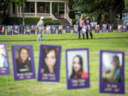 People look at a memorial of overdose victims on Wednesday during a Fentanyl Prevention and Overdose Awareness Day event.