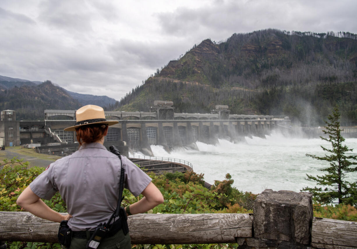 Park Ranger Meg Sleeper l        ooks at the Bonneville Dam spillway Thursday.