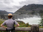 Park Ranger Meg Sleeper l        ooks at the Bonneville Dam spillway Thursday.