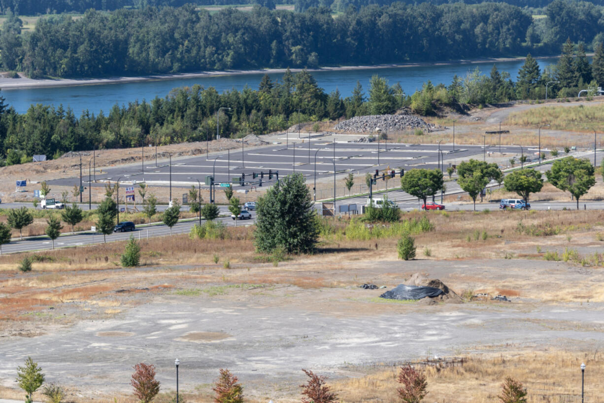 A parking lot and an empty lot border the intersection of Southeast Brady Road and Southeast 192nd Avenue. The entire Fisher Quarry area is planned to become two massive mixed-use developments.