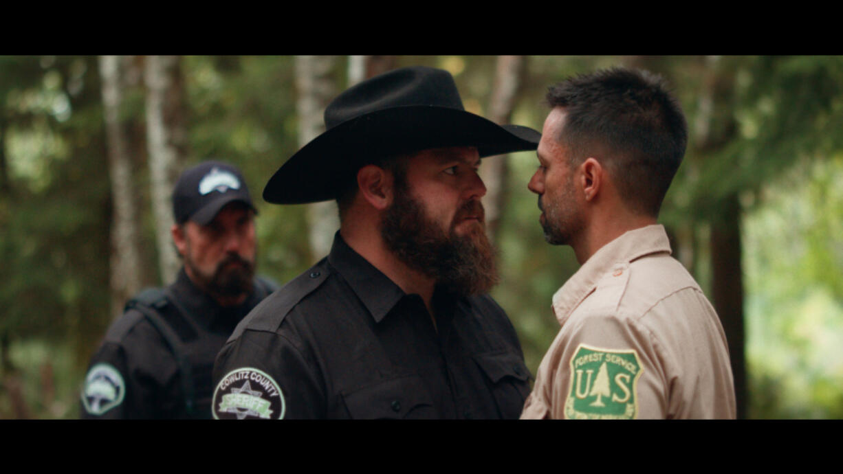 The Cowlitz County sheriff (Jack Vanover, center) and a U.S.