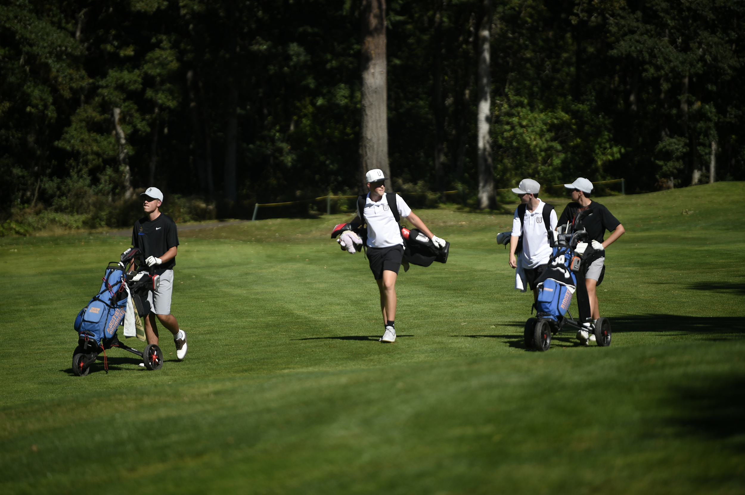 Golfers (from left) Drew Krsul of Ridgefield, Mason Bluestein and Scott Whitman of Union and Brody Newcombe of Ridgefield walk down the No. 3 fairway at Camas Meadows Golf Club during a high school boys golf match on Thursday, Aug. 29, 2024.