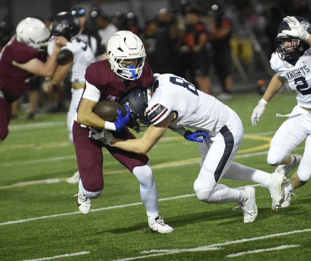 Prairie junior Jackson Kimball is hit by King's Way Christian junior Sam Somarakis (8) during a preseason football jamboree at District Stadium in Battle Ground on Friday, Aug. 30, 2024.