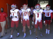 Eastern Washington's Freddie Roberson (1), Nolan Ulm (17), Anthony Stell Jr. (3) and Kekoa Visperas (16) walk onto the field before an NCAA college football game against Florida, Sunday, Oct. 2, 2022, in Gainesville, Fla. (AP Photo/Phelan M.