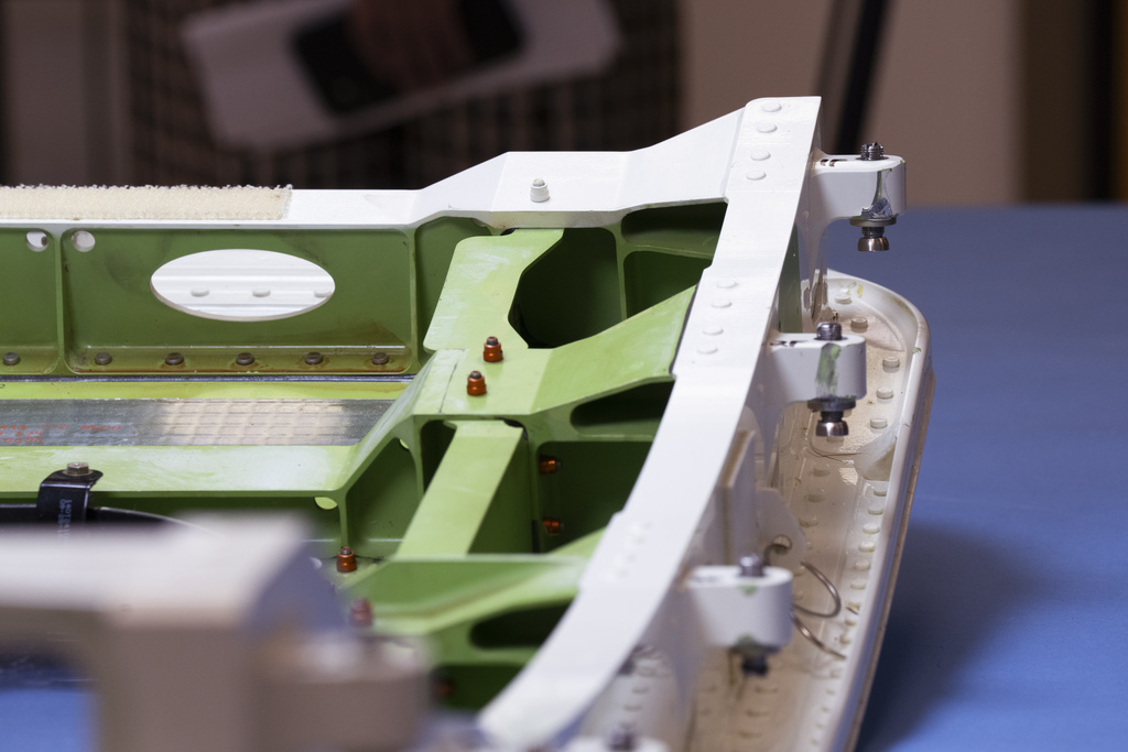 The top section of the door plug from the Alaska Airlines Flight 1282's Boeing 737-9 MAX airplane is shown at the National Transportation Safety Board laboratory, in Washington, Tuesday, July 30, 2024. The door plug is showing damaged bolts on the top right corner.