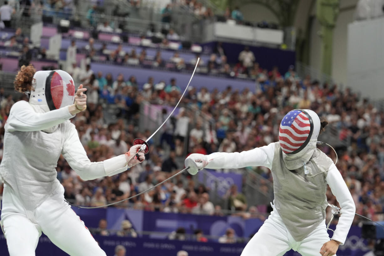 United States' Lee Kiefer, right, competes with Canada's Eleanor Harvey in the women's team foil semifinal match during the 2024 Summer Olympics at the Grand Palais, Thursday, Aug. 1, 2024, in Paris, France.