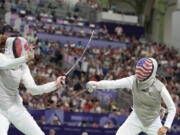 United States' Lee Kiefer, right, competes with Canada's Eleanor Harvey in the women's team foil semifinal match during the 2024 Summer Olympics at the Grand Palais, Thursday, Aug. 1, 2024, in Paris, France.