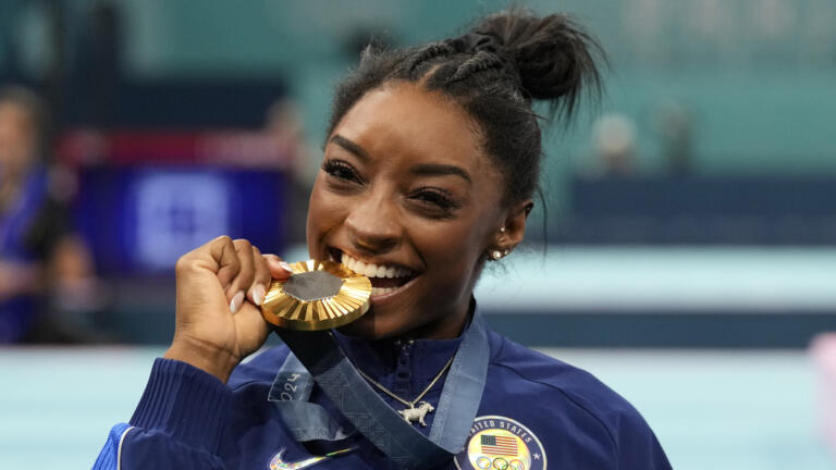 Simone Biles, of the United States, celebrates after winning the gold medal during the women's artistic gymnastics all-around finals in Bercy Arena at the 2024 Summer Olympics, Thursday, Aug. 1, 2024, in Paris, France.