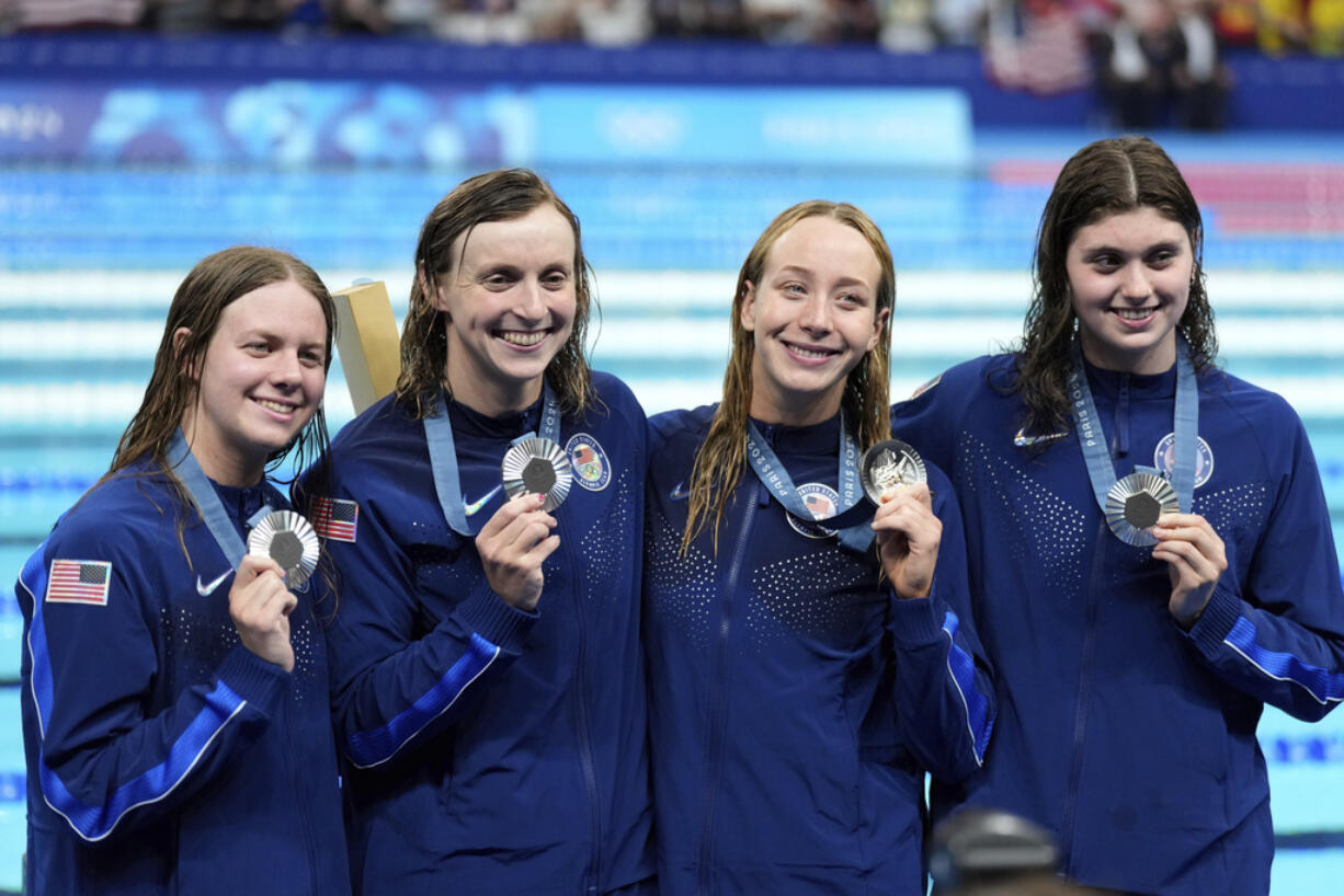 United States' women's 4x200-meter freestyle relay team members celebrate with their silver medals at the 2024 Summer Olympics in Nanterre, France, Thursday, Aug. 1, 2024.