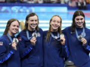 United States' women's 4x200-meter freestyle relay team members celebrate with their silver medals at the 2024 Summer Olympics in Nanterre, France, Thursday, Aug. 1, 2024.