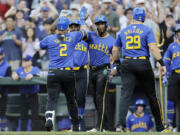 Seattle Mariners' Justin Turner (2) celebrates at home after his grand slam off Philadelphia Phillies starting pitcher Tyler Phillips during the second inning in a baseball game, Friday, Aug. 2, 2024, in Seattle.