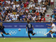 Trinity Rodman of the United States, right, scores the opening goal during the quarterfinal women's soccer match between the United States and the Japan at the Parc des Princes at the 2024 Summer Olympics, Saturday, Aug. 3, 2024, in Paris, France.