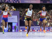 Julien Alfred, of Saint Lucia, celebrates after winning the women's 100-meter final at the 2024 Summer Olympics, Saturday, Aug. 3, 2024, in Saint-Denis, France. (AP Photo/David J.