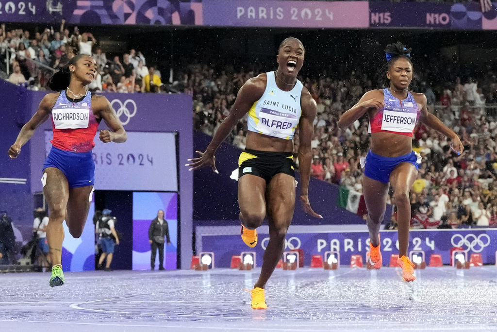 Julien Alfred, of Saint Lucia, celebrates after winning the women's 100-meter final at the 2024 Summer Olympics, Saturday, Aug. 3, 2024, in Saint-Denis, France. (AP Photo/David J.