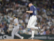 Seattle Mariners pitcher Trent Thornton kicks the mound as Detroit Tigers' Parker Meadows, back, rounds the bases on his solo home run during the eighth inning in a baseball game, Tuesday, Aug. 6, 2024, in Seattle.