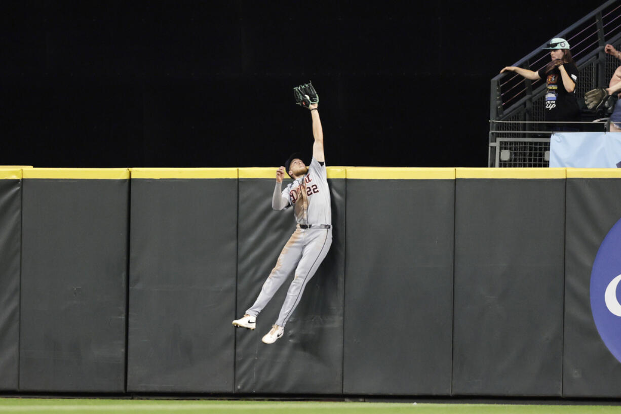 Detroit Tigers center fielder Parker Meadows leaps and catches a ball hit by Seattle Mariners' Cal Raleigh during the eighth inning in a baseball game, Wednesday, Aug. 7, 2024, in Seattle.