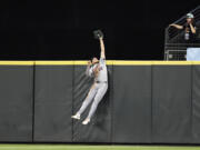 Detroit Tigers center fielder Parker Meadows leaps and catches a ball hit by Seattle Mariners' Cal Raleigh during the eighth inning in a baseball game, Wednesday, Aug. 7, 2024, in Seattle.