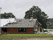 Parts of Springfield Middle School lay on the ground after being ripped off by a tornado, spawned by Tropical Storm Debby, in Lucama, N.C., Thursday, Aug. 8, 2024.