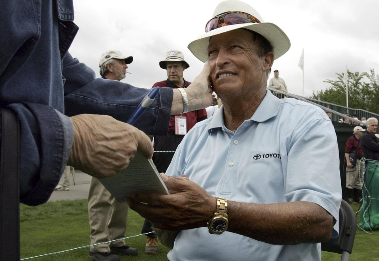 FILE - Chi Chi Rodriguez, of Puerto Rico, smiles while signing an autograph at the Nashawtuc Country Club in Concord, Mass., Friday, June 9, 2006.