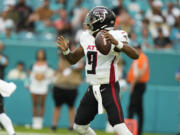 Atlanta Falcons quarterback Michael Penix Jr. (9) aims a pass during the first half of a pre season NFL football game against the Miami Dolphins, Friday, Aug. 9, 2024, in Miami Gardens, Fla.