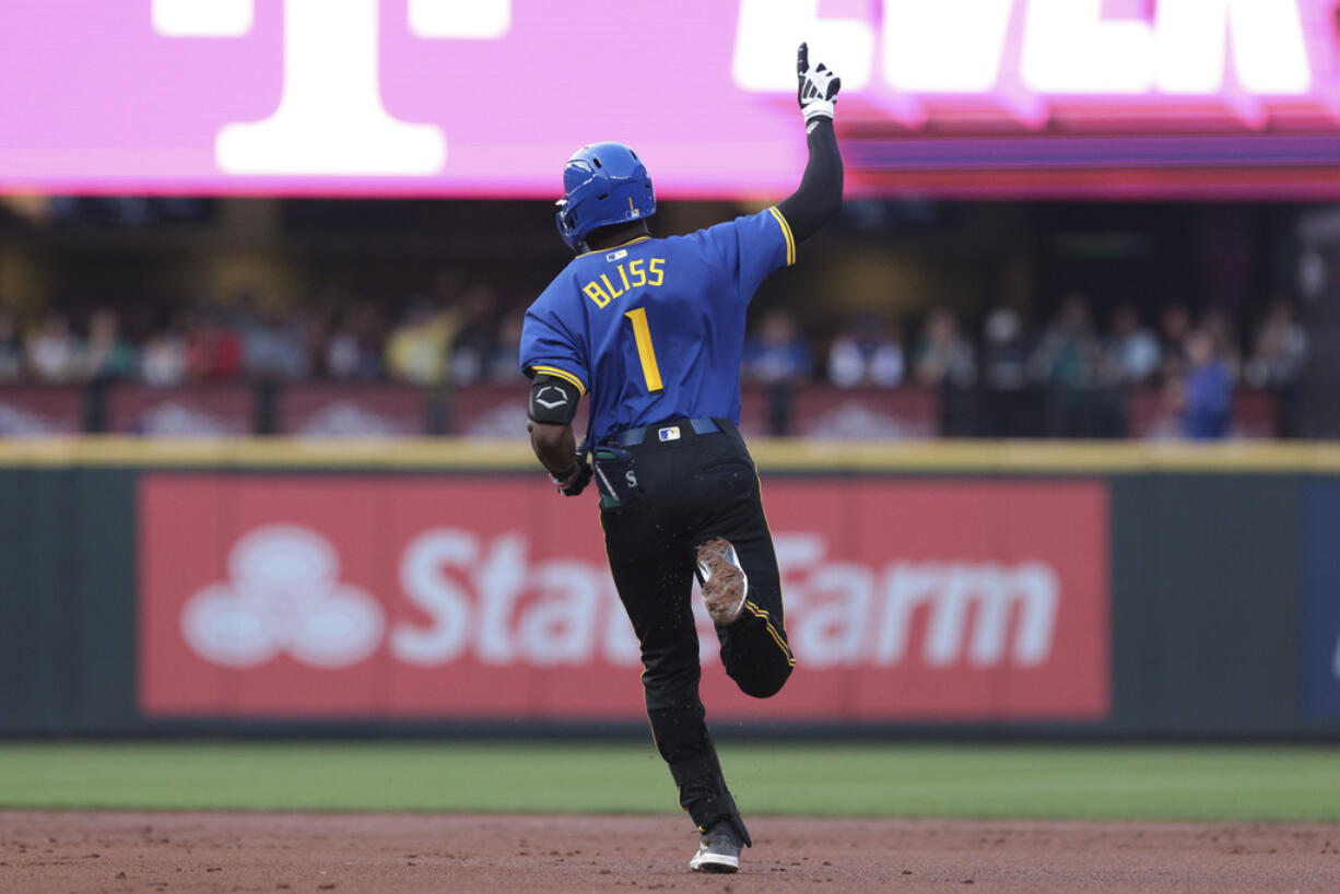 Seattle Mariners second baseman Ryan Bliss (1) rounds second base after hitting a two-run home run off New York Mets starting pitcher Jose Quintana (62) during the second inning of a baseball game, Friday, Aug. 9, 2024, in Seattle.