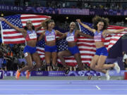 The United States' women 4x400-meter relay team celebrates winning the gold medal at the 2024 Summer Olympics, Saturday, Aug. 10, 2024, in Saint-Denis, France.