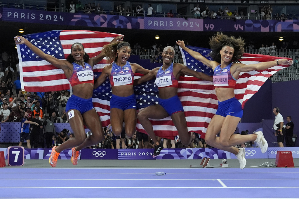 The United States' women 4x400-meter relay team celebrates winning the gold medal at the 2024 Summer Olympics, Saturday, Aug. 10, 2024, in Saint-Denis, France.