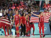 The United States team celebrates after a women's gold medal basketball game at Bercy Arena at the 2024 Summer Olympics, Sunday, Aug. 11, 2024, in Paris, France. (AP Photo/Mark J.