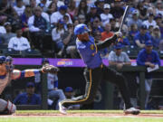 Seattle Mariners' Victor Robles, right, hits the ball for a foul during the first inning of a game against the New York Mets, Sunday, Aug. 11, 2024, in Seattle.