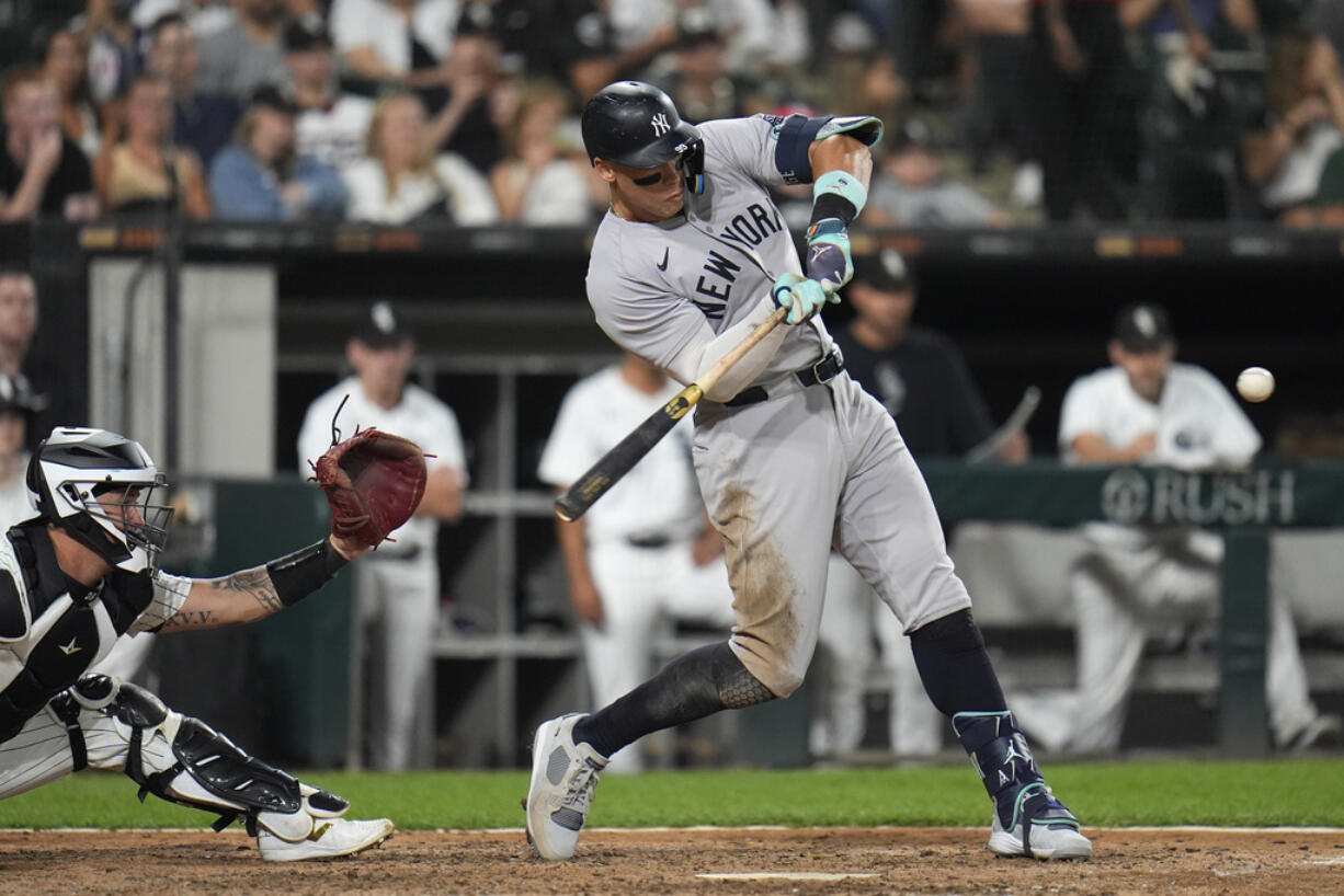 New York Yankees designated hitter Aaron Judge hits his 300th career home run, the fastest playing in MLB history to do so, during the eighth inning of a baseball game against the Chicago White Sox, Wednesday, Aug. 14, 2024, in Chicago.