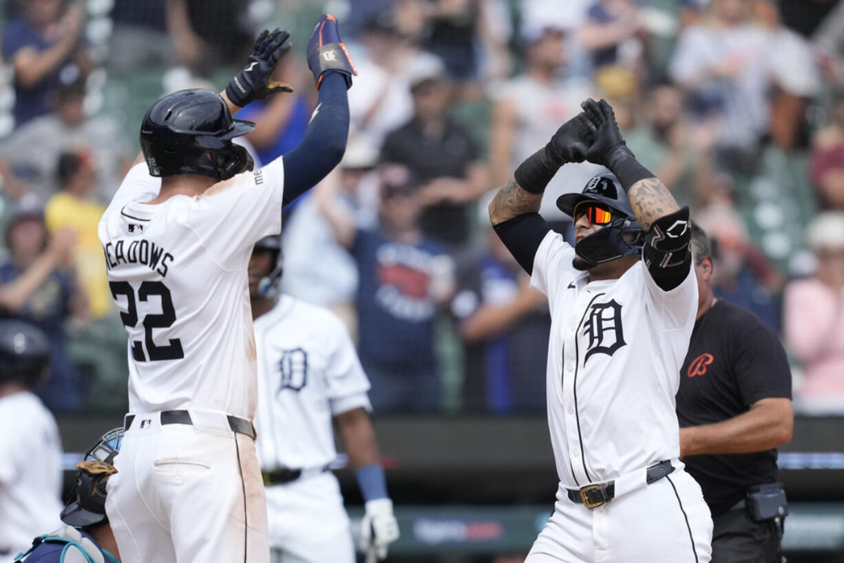 Detroit Tigers' Javier Báez, right, is greeted by Parker Meadows after a two-run home run during the eighth inning of a baseball game against the Seattle Mariners, Thursday, Aug. 15, 2024, in Detroit.